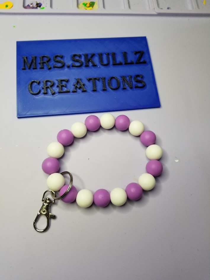 purple and white wristlet key ring